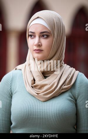 Beautiful Pensive muslim woman looking away outdoors Stock Photo
