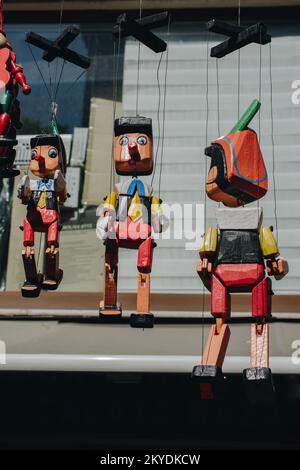 Wooden pinocchio dolls with long nose. Conceptual fairy tale character Stock Photo