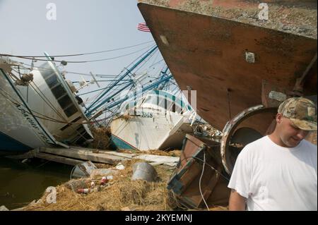 Hurricane Katrina, Plaquemines Parish, LA, 9/21/2005 -- Kevin Drury, a shrimp fisherman, walks away from his destroyed fishing boat following Hurricane Katrina. Andrea Booher/FEMA Stock Photo