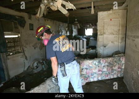 Hurricane Katrina, New Orleans, LA, 10/22/2005 -- New Orleans Firefighter, Autrey Plaisance searches inside a damaged home for missing people in the Lower 9th Ward following Hurricane Katrina. FEMA photo/Andrea Booher Stock Photo