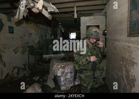 Hurricane Katrina, New Orleans, LA., 10/22/2005 -- National Guard Major Heaton is inside a damaged home and talks on a two way radio during a search in the Lower 9th Ward following hurricane Katrina. FEMA photo/Andrea Booher Stock Photo