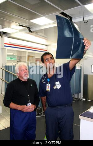 Hurricane Katrina, Plaquemines Parish, LA, November 7, 2005 - Radiologst Jim Borel and doctor Vivek Parwani look at a patient's digital X-ray taken in the innovative Mobile Medical Unit (MMU) set up by FEMA in this hurricane-ravaged area east of New Orleans. Other advanced features of the MMU include an operating room and a pharmacy. Stock Photo