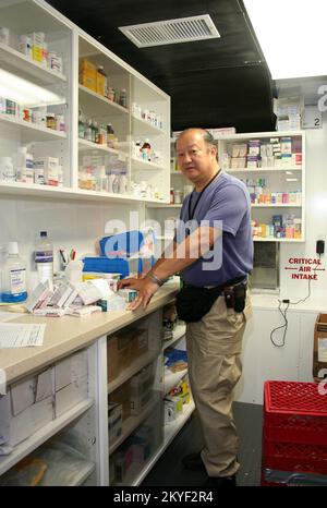 Hurricane Katrina, Plaquemines Parish, LA, November 7, 2005 -- Pharmacist Irwin Chow organized a new shipment of medical supplies in the new and innovative Mobile Medical Unit FEMA set up in the hurricane-ravaged area of soutern Louisiana. Local residents who lost access to medical care can get comprehensive treatment at the MMU. Stock Photo