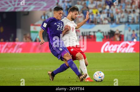 Al Wakrah, Qatar. 30th Nov, 2022. Argentina's Nahuel Molina and Poland's Bartosz Bereszynski fight for the ball during a soccer game between Poland and Argentina, the third and last game in Group C of the FIFA 2022 World Cup in Al Wakrah, State of Qatar on Wednesday 30 November 2022. BELGA PHOTO VIRGINIE LEFOUR Credit: Belga News Agency/Alamy Live News Stock Photo