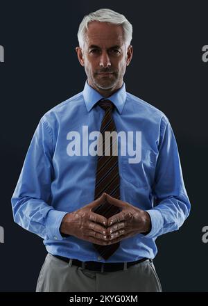 Coming up with a winning strategy. A mature man looking at the camera in a thoughtful pose. Stock Photo