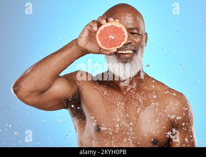 Beauty, water splash or senior black man with grapefruit for body care, healthcare or skincare health. Happy face, smile or facial portrait of elderly Stock Photo