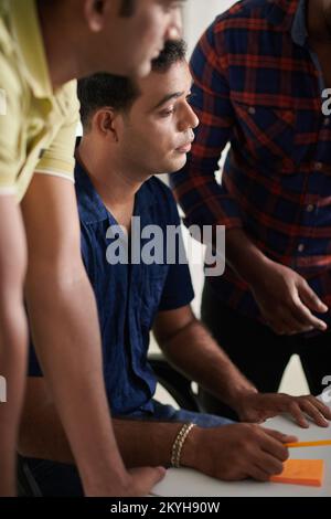 Team of UX designers working on interface of new mobile application Stock Photo