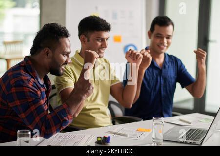 Team of developers and UX designers celebrating success of their project Stock Photo