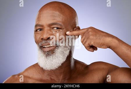 Beauty, cream and senior black man portrait with under eye cosmetic product dots on natural face. Wellness, skincare and health of mature model with Stock Photo