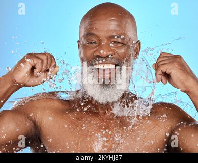 Black man, water splash and flossing teeth for dental health, hygiene and wellness on blue studio background. African senior model with floss cleaning Stock Photo