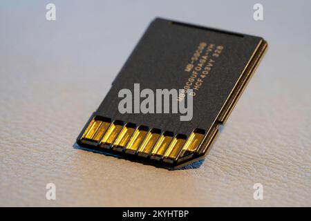Close up of a Fast SD Card on grey textured background Stock Photo