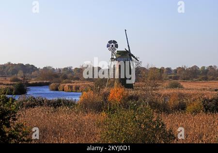 A view of the redundant Turf Fen Drainage Mill by the River Ant on the Norfolk Broads in autumn from How Hill, Ludham, Norfolk, England, UK. Stock Photo