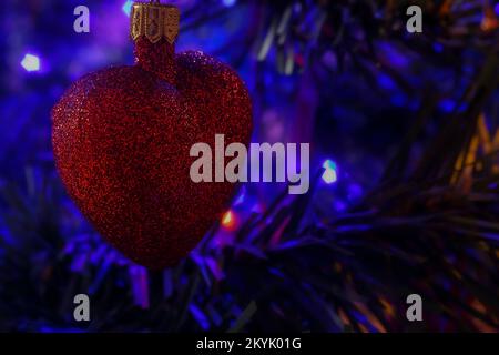 Heart-shaped Christmas tree ball on a Christmas tree Stock Photo - Alamy