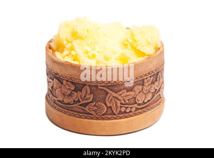 Ghee in wooden bowl isolated on white background. Stock Photo