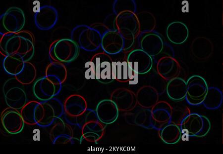 Dark background with circles of the rainbow.Funny seamless bakground with strange colors on black background. original and mystical colors in seamless Stock Photo