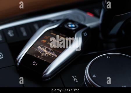 MOSCOW, RUSSIA - FEBRUARY 05, 2022. BMW smart key close up view. Modern BMW wireless car key. Translation: 'Opened. Connected.' Stock Photo