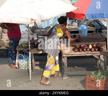 Woman arranging her display of avocadoes. Local Market, Kinshasa, Democratic Republic of the Congo Stock Photo