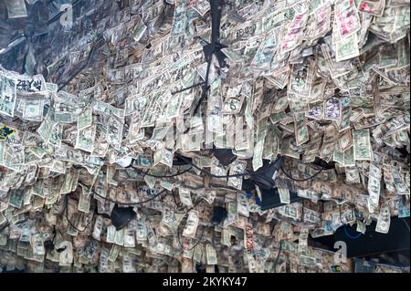 Key West, Florida : Willie T's famous bar pub with many hanging US dollar bills banknotes on ceiling inside of restaurant Stock Photo