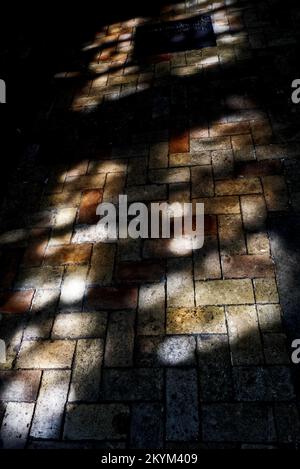light pattern from stain glass window on paved floor of a church Stock Photo