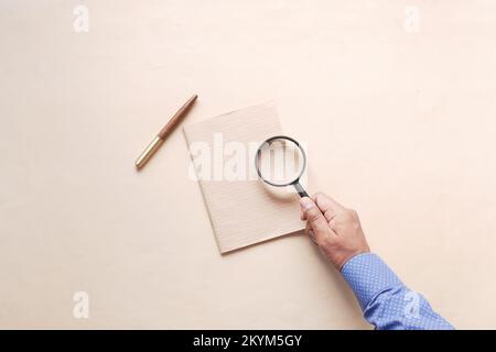 hand in magnifying glass inspecting 404 error.  Stock Photo