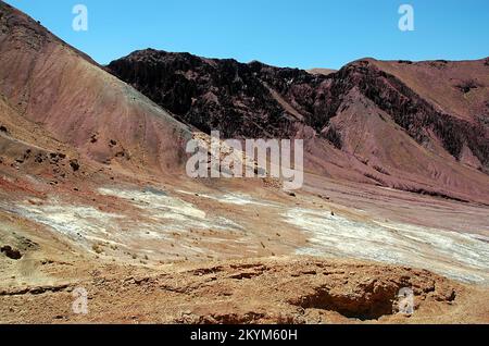 Red, magenta mountain scenery in the Kalu Valley near Bamyan (Bamiyan), Afghanistan. Taken on the southern route between the two cities. Stock Photo