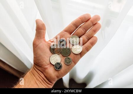 Lovran, Croatia - September 12, 2022: Man holding croatian Kuna and Lipa coins in hand. Kuna is currency in Croatia used since 1194 and will be in use Stock Photo