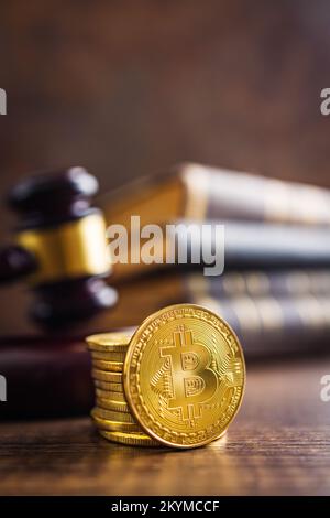 Cryptocurrency. Bitcoin virtual money. Golden coins and the judge gavel. Stock Photo