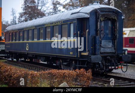 01 December 2022, Mecklenburg-Western Pomerania, Gadebusch: The sleeping car from the legendary Orient Express built in 1941 is parked on the museum track next to the historic train station. The wagon is now parked on the museum track next to the historic train station. Once used between Paris and Istanbul, the 54-ton wagon was lifted by two truck-mounted cranes from the Deutsche Bahn operating track into the museum area during the night. Photo: Jens Büttner/dpa Stock Photo