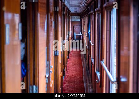 01 December 2022, Mecklenburg-Western Pomerania, Gadebusch: The passage to the compartments of the sleeping car built in 1941 from the legendary Orient Express. The wagon is now parked on the museum track next to the historic station. Once used between Paris and Istanbul, the 54-ton wagon was lifted by two truck-mounted cranes from the Deutsche Bahn operating track into the museum area during the night. Photo: Jens Büttner/dpa Stock Photo