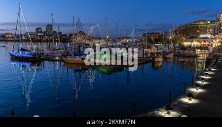 The harbour in Victoria, British Columbia, seen at dusk with holiday lights. Stock Photo