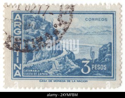 ARGENTINA - 1960: 3 pesos dark blue postage stamp depicting Zapata Slope, Catamarca. Catamarca is a province of Argentina, located in the northwest of the country. Its literacy rate is 95,5%. Neighbouring provinces are (clockwise, from the north): Salta, Tucuman, Santiago del Estero, Cardoba, and La Rioja. To the west it borders the country of Chile. The capital is San Fernando del Valle de Catamarca, usually shortened to Catamarca. Other important cities include Andalgalá, Tinogasta, and Belen. Most of Catamarca's territory is covered by mountains (80%) Stock Photo