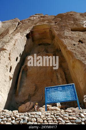 Bamyan (Bamiyan) in Central Afghanistan. This is the site of the small Buddha niche with an information sign and workers. Stock Photo