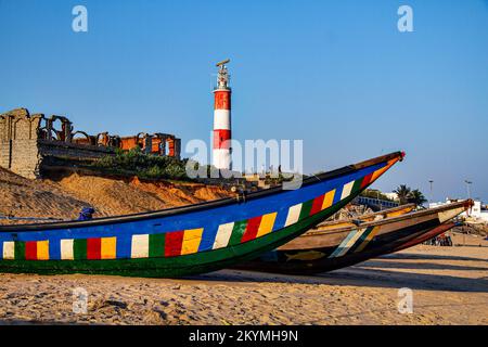 Colourful fishing boats on beach in Odisha in India with blue sea and sky Stock Photo
