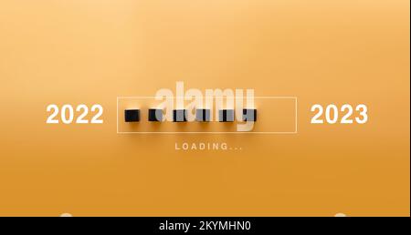 Loading new year 2022 to 2023 with hand putting wood cube in progress bar. Start new year 2023 with goal plan, goal concept, strategy. Stock Photo