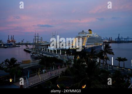 View of cruise liner “Spirit of Adventure” moored at night in Las Palmas cruise terminal in La Isleta commercial port by Comercial El Muelle shopping Stock Photo