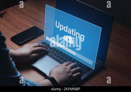 Woman updating software on laptop. System engineer and programming. Software apps developer. Stock Photo