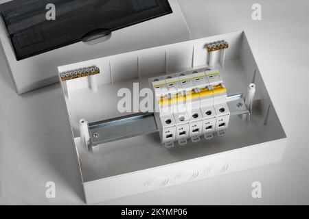Plastic distribution board. Electrical board. Close-up. Isolated on light gray background. Stock Photo