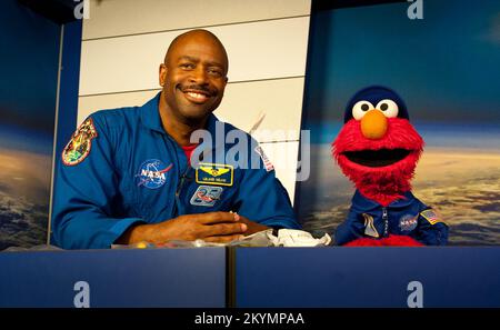 NASA Associate Administrator for Education and former astronaut Leland Melvin teaches the ABC's of living and working in space to Sesame Street's Elmo at NASA's Kennedy Space Center, Wednesday, July 6, 2011 in Cape Canaveral, FL.  The pair discussed nutrition, exercise, hygiene in orbit.  They also chatted about the features of the space shuttle and the various suits that astronauts wear.  Photo Credit:  (NASA/Carla Cioffi) Stock Photo