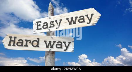 Easy way and hard way - wooden signpost with two arrows Stock Photo