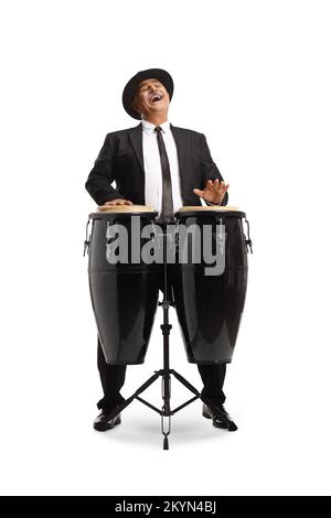 Cheerful mature man playing conga drums and singing isolated on white background Stock Photo