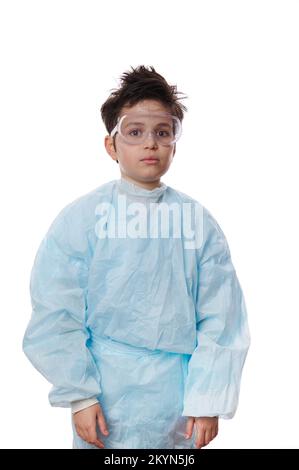 Vertical studio portrait on white background of a teenage schoolboy, chemist scientist in lab coat, looking at camera Stock Photo