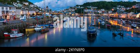 LOOE, CORNWALL - JUNE 06, 2009:  Panorama view of the harbour and town at night with lights reflected in the water Stock Photo