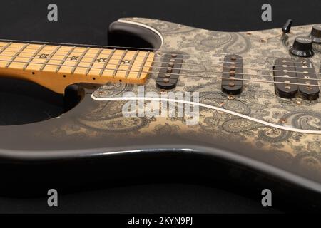 Vaduz, Liechtenstein, January 12, 2022 Product shot of a Fender Stratocaster Richie Sambora signature electric guitar painted in black paisley Stock Photo