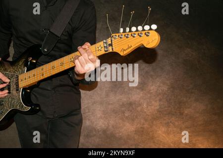 Vaduz, Liechtenstein, January 12, 2022 Artist is playing with a Fender Stratocaster Richie Sambora signature electric guitar Stock Photo