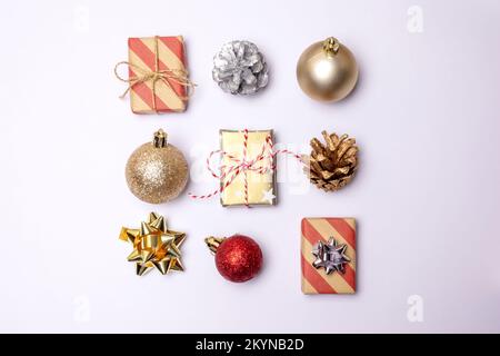 Christmas square composition. Christmas gifts, red and golden balls, pine cones on white background. Flat lay, top view Stock Photo