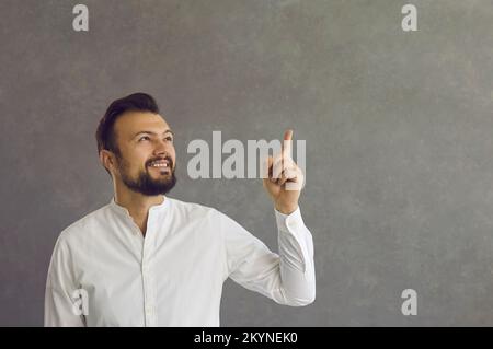 The young man shows his forefinger up Stock Photo