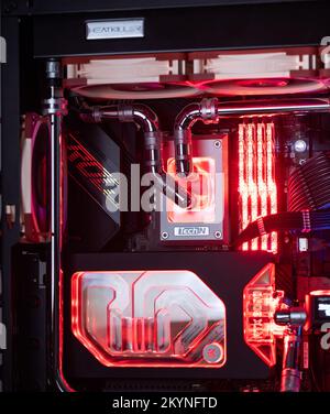Prague, Czech Republic - 21 July 2021: Close-up of high performance Desktop PC and water cooling system with multicolored LED RGB light show status on Stock Photo