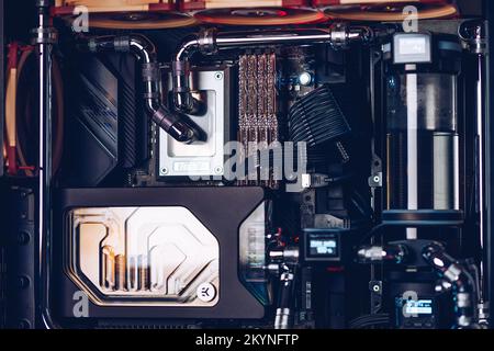 Prague, Czech Republic - 21 July 2021: Close-up of high performance Desktop PC and water cooling system with multicolored LED RGB light show status on Stock Photo