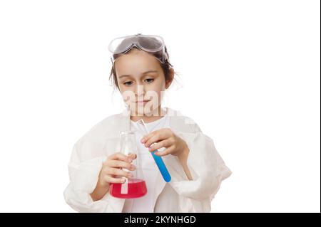 Hands of a little girl in lab coat, holdin laboratory test tube and flask with chemicals and reagents, isolated on white Stock Photo