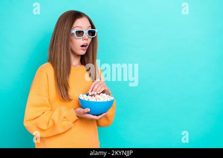 Photo of young girl teen age hold popcorn eat snacks junk food wear 3d glasses shocked look mockup trailer new film isolated on cyan color background Stock Photo
